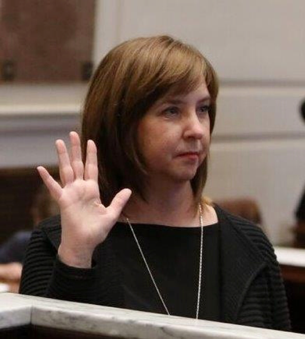 Senator Mary Boren, D-Norman, raises her hand as she is sworn into office during a ceremony at the state Capitol on Wednesday.