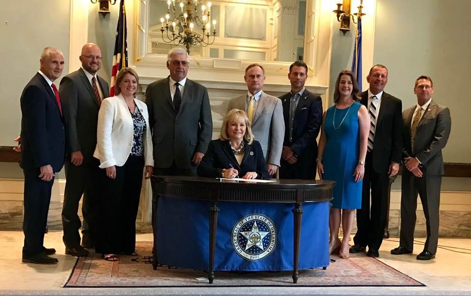Several attended the ceremonial bill signing of SB 1294 at the state Capitol.  Pictured from left to right are:  Kent Wilkins with Oklahoma Water Resources Board (OWRB), Brent Kisling with Enid Regional Development Alliance (ERDA), Julie Cunningham with OWRB, Senator Roland Pederson, Governor Mary Fallin, Chris Gdanski with the City of Enid Engineering Dept., Michael Graves with Garver Engineering, Lisa Powell with Enid Regional Development Alliance, Duane Smith with Smith and Associates, and Owen Mills with OWRB.