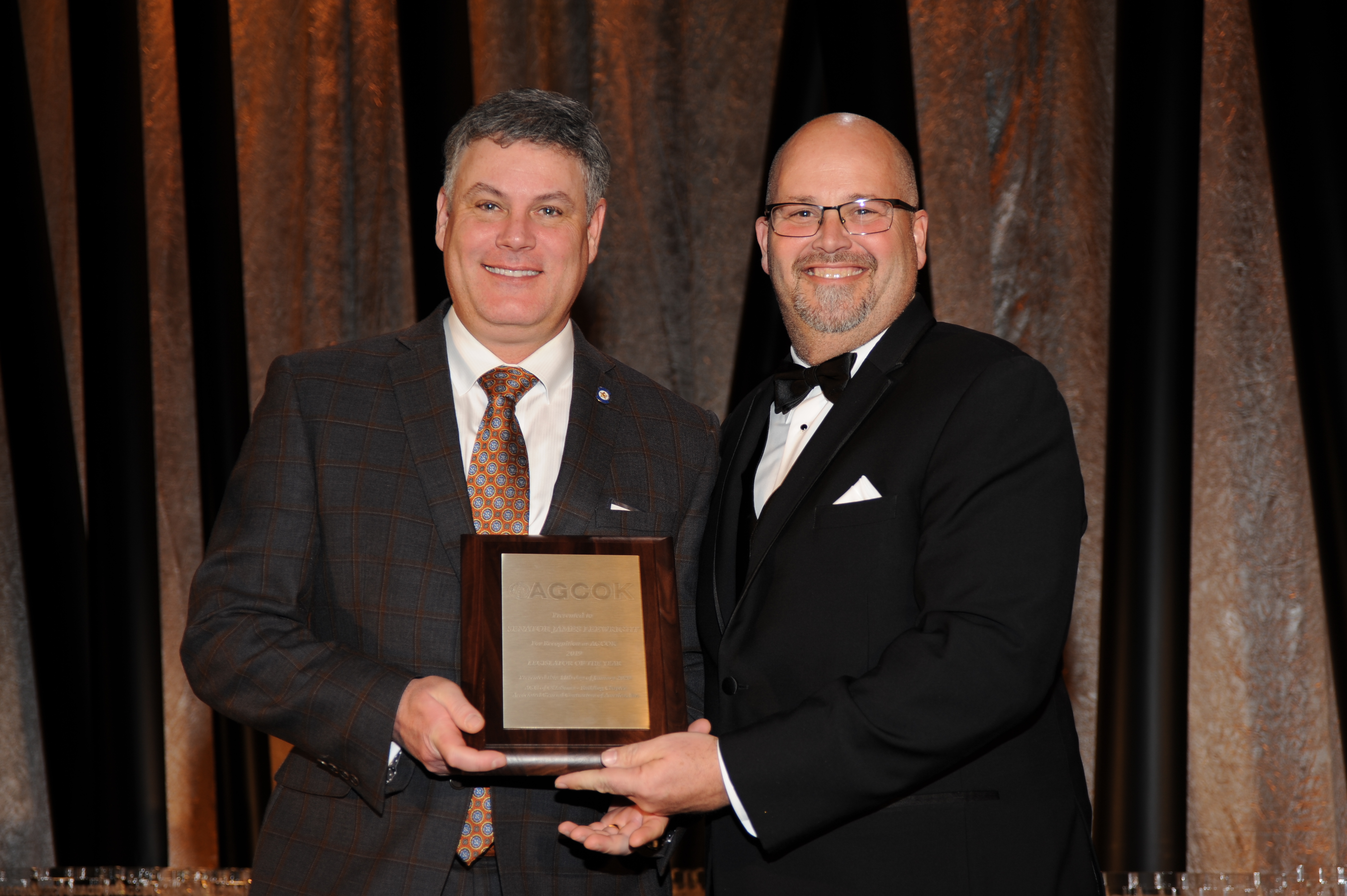 Sen. James Leewright, R-Bristow, is given the Legislator of the Year award by AGCOK President Jeff Kusler.