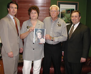 Rep. Fred Morgan, John and Betty LeGrange holding a photo of their daughter, Kristie and Sen. Glenn Coffee