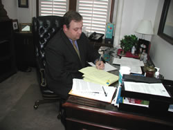 Sen Glenn Coffee in his Capitol office reviews his legislation to require computer techs to report child porn.