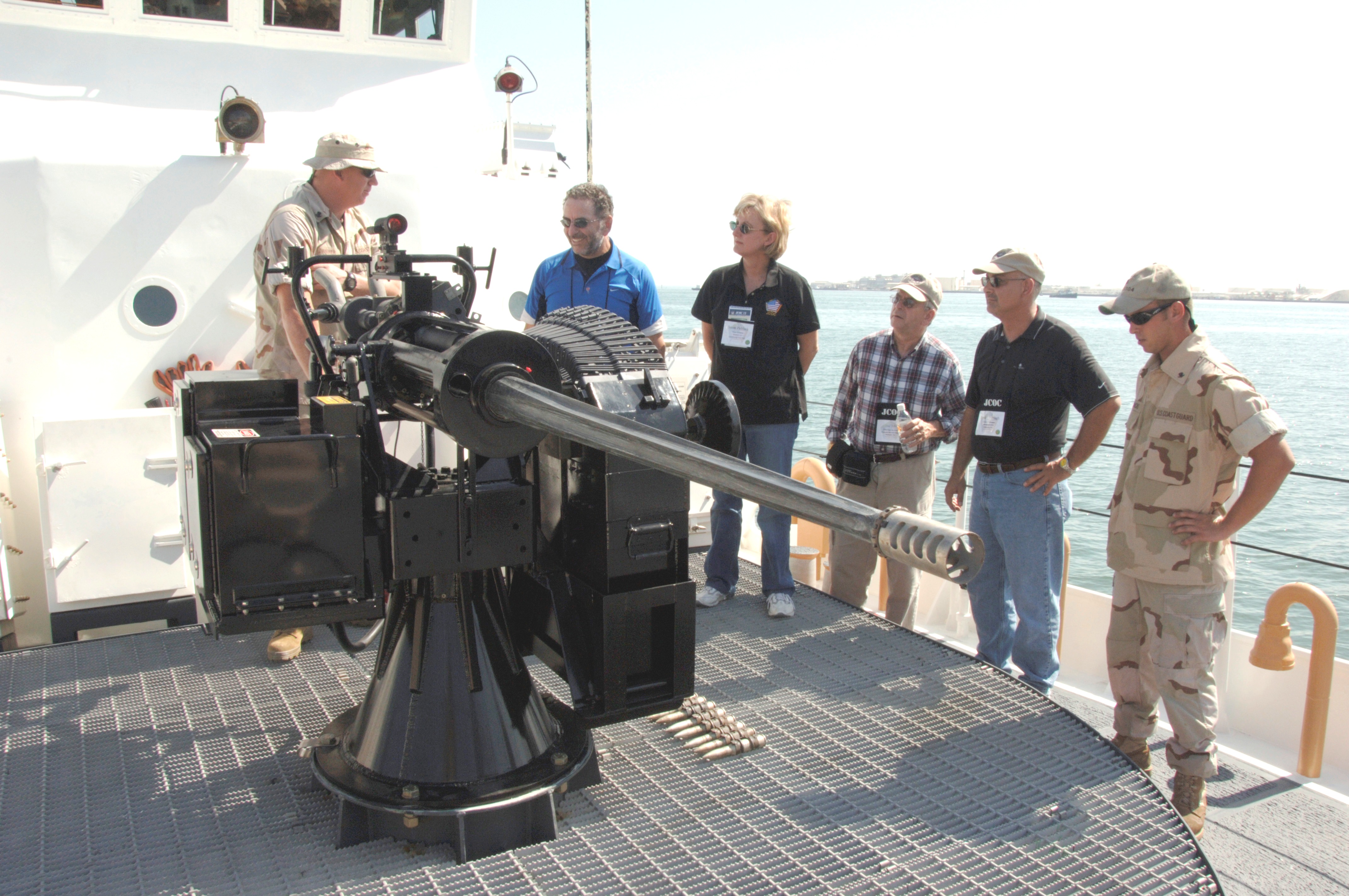 Joint Civilian Orientation Conference participants, including Sen. Susan Paddack (third from left) get a close look at the deck gun of a 110-foot Coast Guard patrol boat in Manama, Bahrain.   