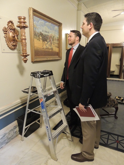 Capitol renovation project manager Trait Thompson and Senate Chief of Staff Randy Dowell admire the historic artifact.